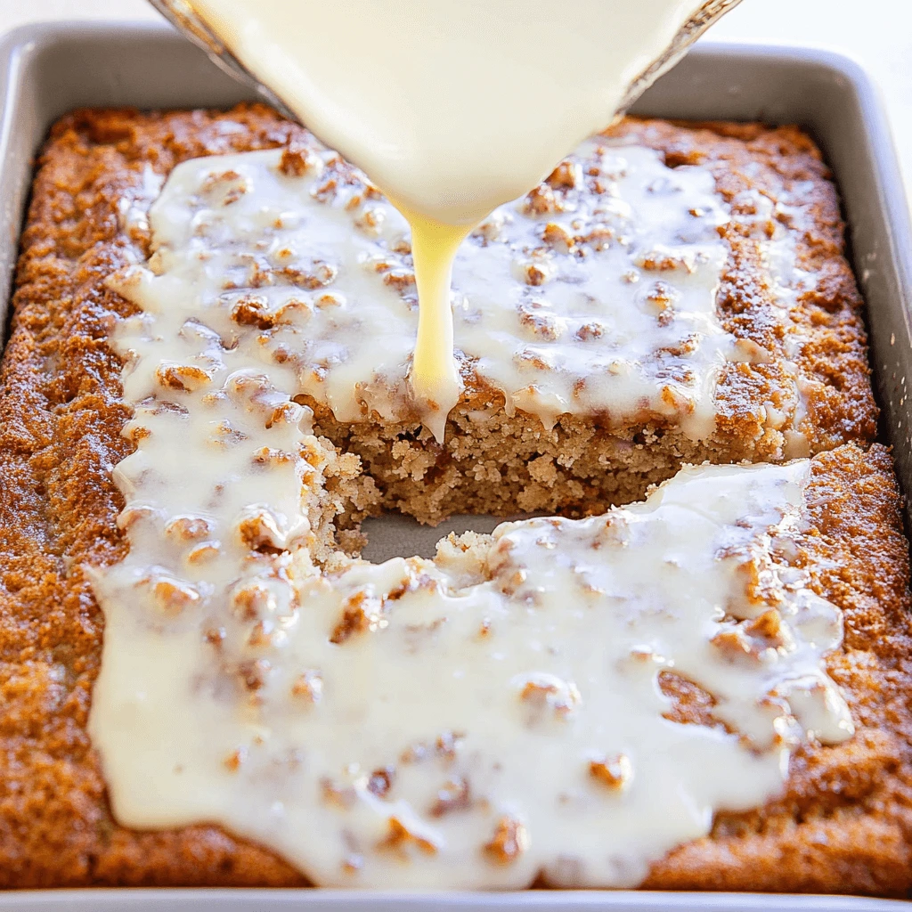 Warm Southern Pecan Praline Poke Cake being drizzled with rich praline glaze.